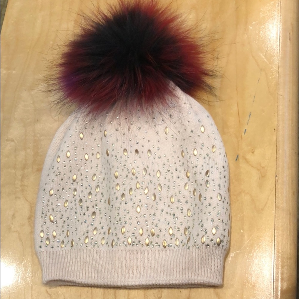 White hat with colorful pom-pom